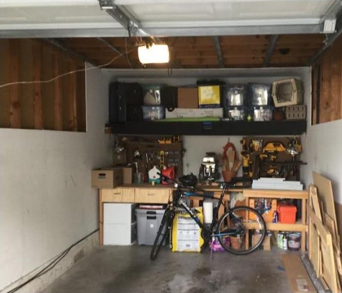 Garage with drywall removed in the ceiling and walls