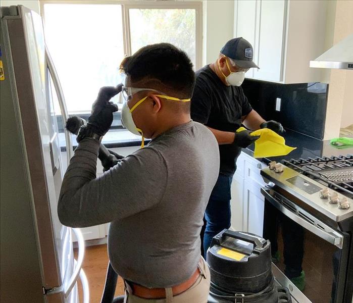 SERVPRO team cleaning a kitchen